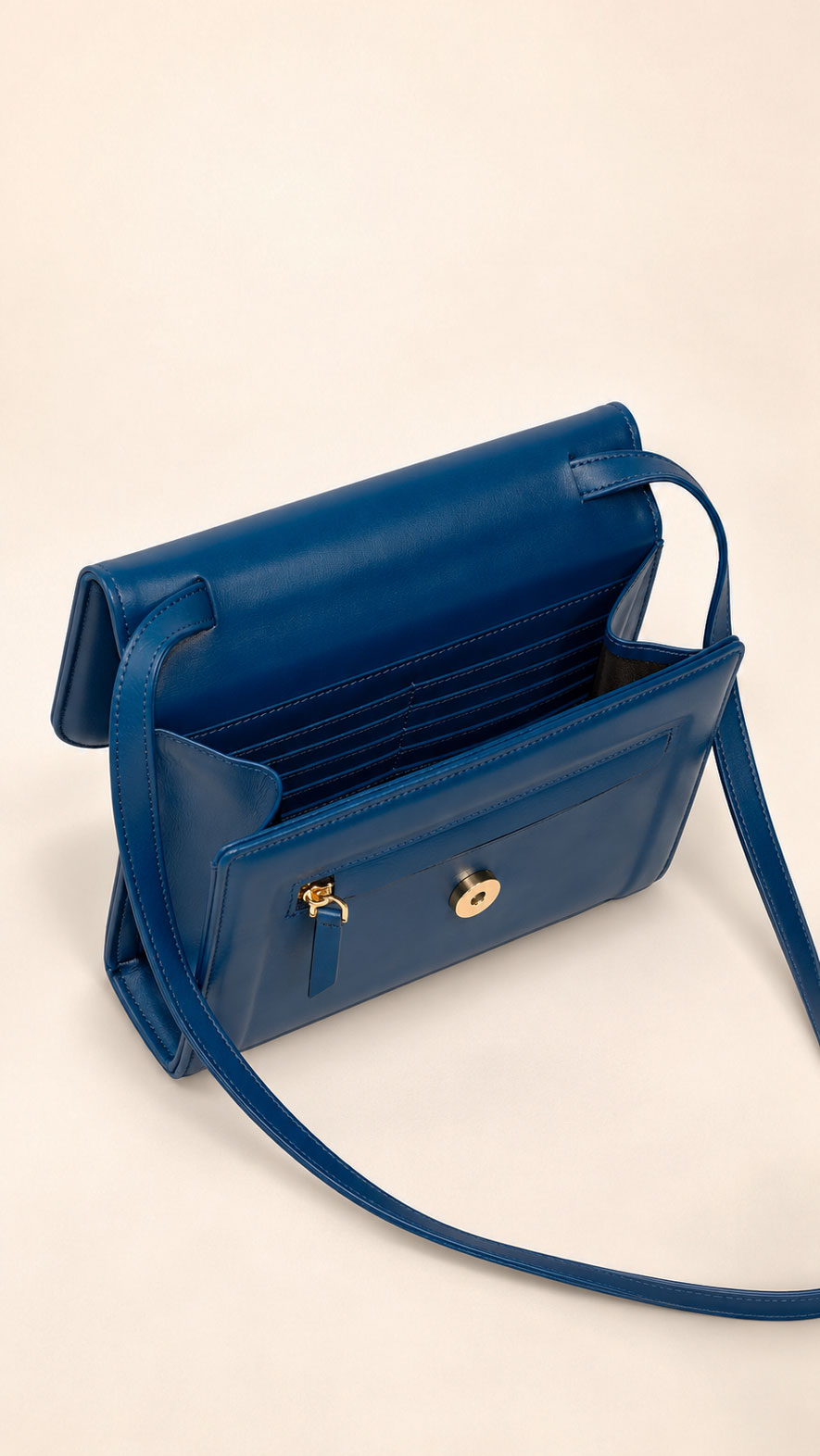 Inside navy leather crossbody bag 10503 showing card slots, zip pocket, and magnetic snap
