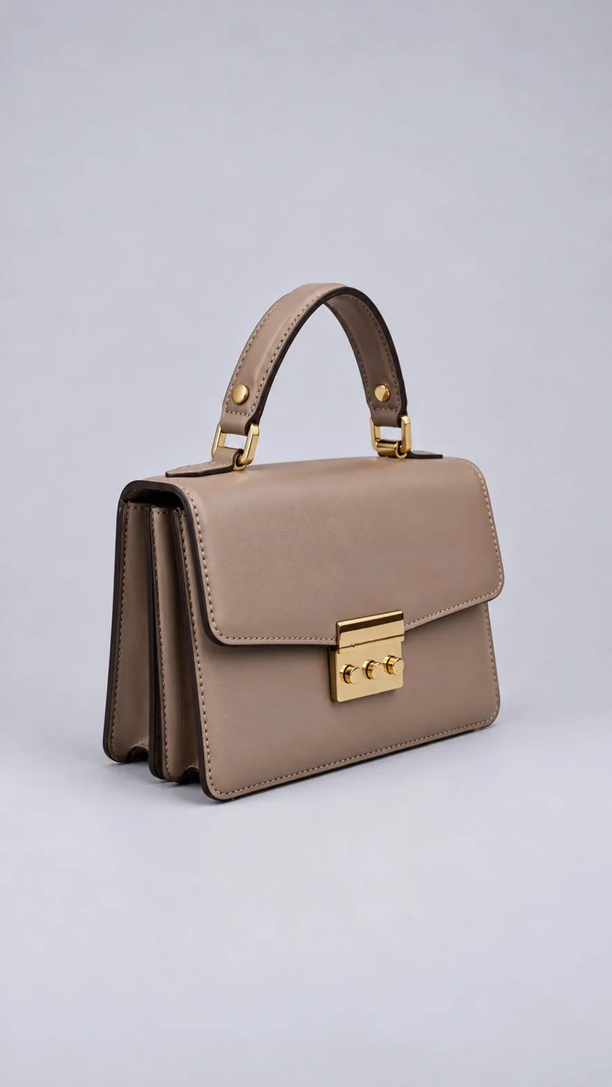 HB0741 taupe leather handbag showing gold clasp and accordion side gussets, angled view